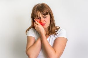 Woman suffering from toothache isolated on white background