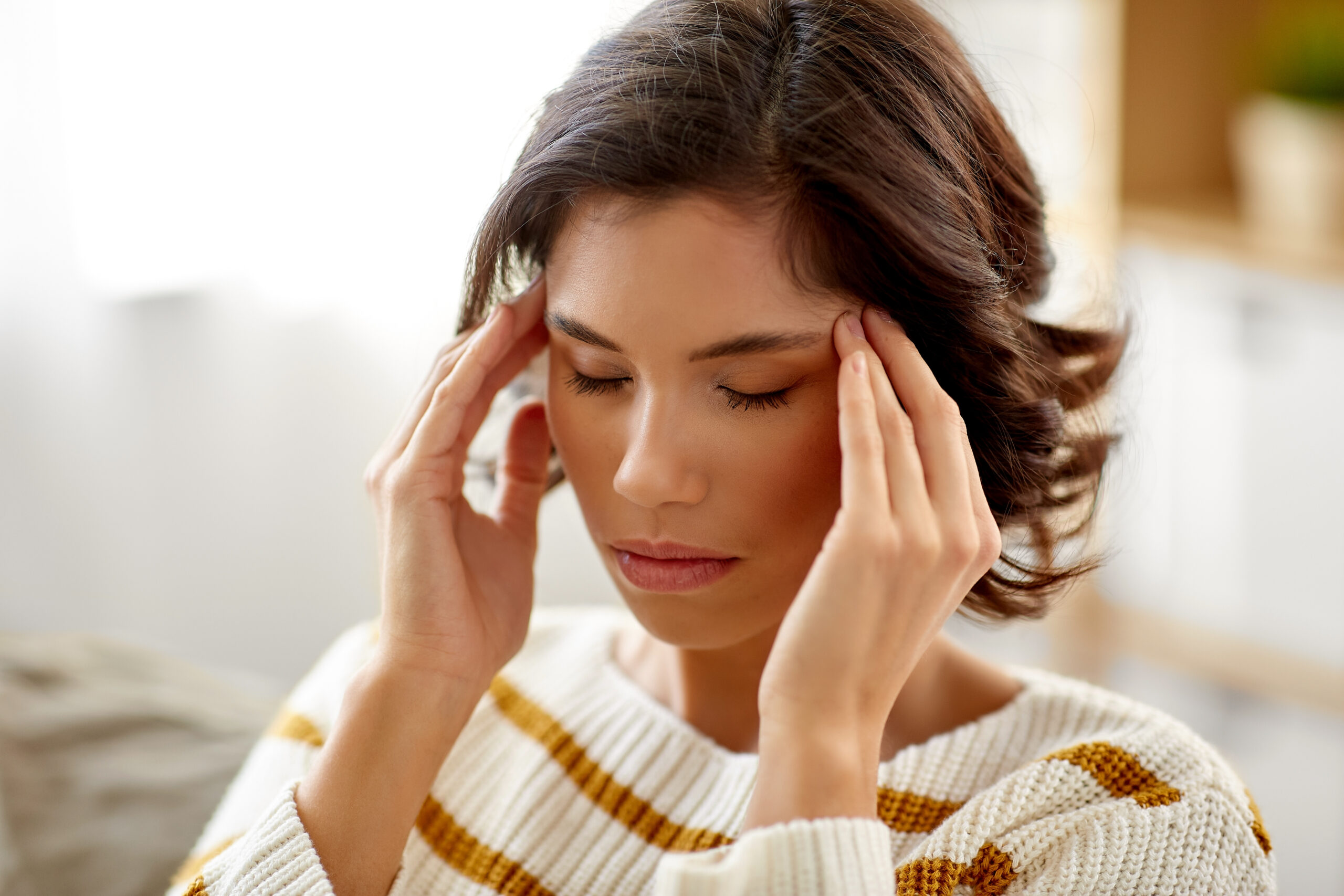 people , health and stress concept - unhappy woman suffering from head ache at home